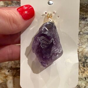 Amethyst and gold metal pendant